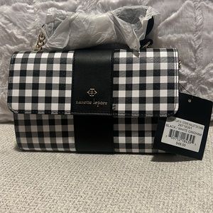 Small whit/black gingham crossbody purse with gold chain strap.